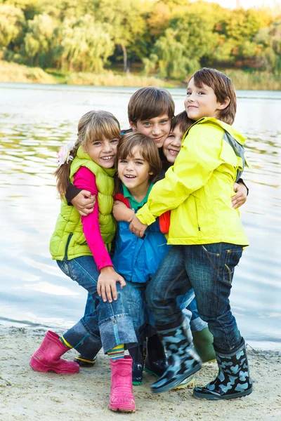 Kids playing beside pond