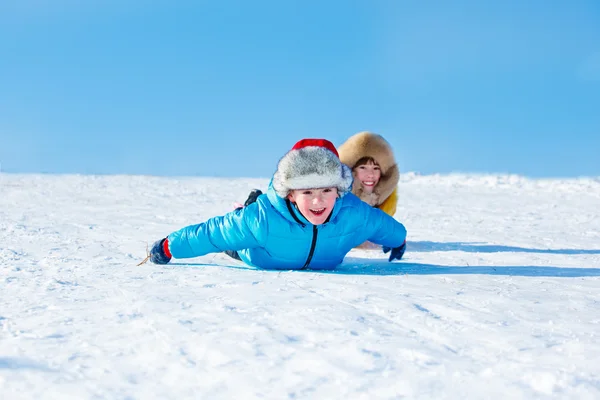 Sister and brother sliding down — Stockfoto