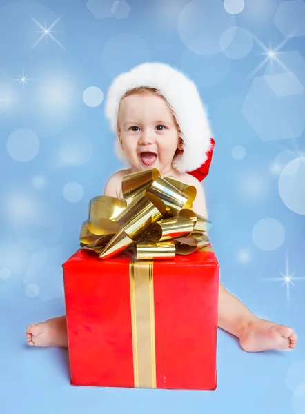 Little boy beside Christmas present — Stock Photo, Image