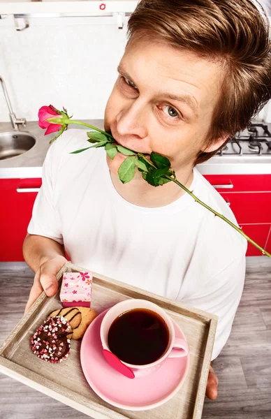 Young man with rose in mouth — Stock Photo, Image