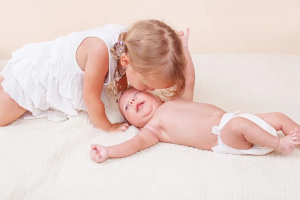 Sister kissing her baby brother — Stock Image Sister kissing her baby brother Stock Image