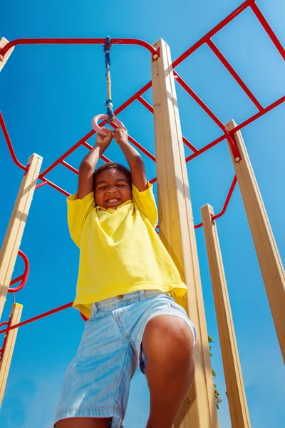 Hanging on gymnastic rings — Stock Photo, Image