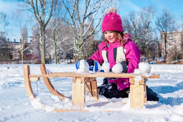 Preschool girl making snowballs — Stock Photo, Image