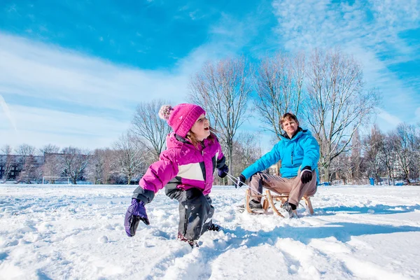 Girl pulling sledges — Stock Photo, Image