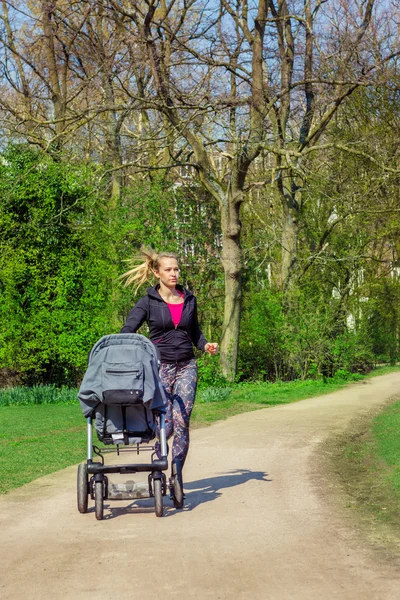 Jogging with a baby buggy — Stock Photo, Image