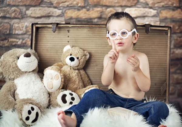 Small cute kid with teddybears Royalty Free Stock Photos
