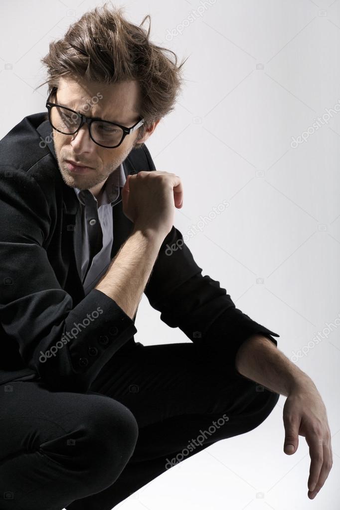 Fashion portrait of the beautiful man over gray background