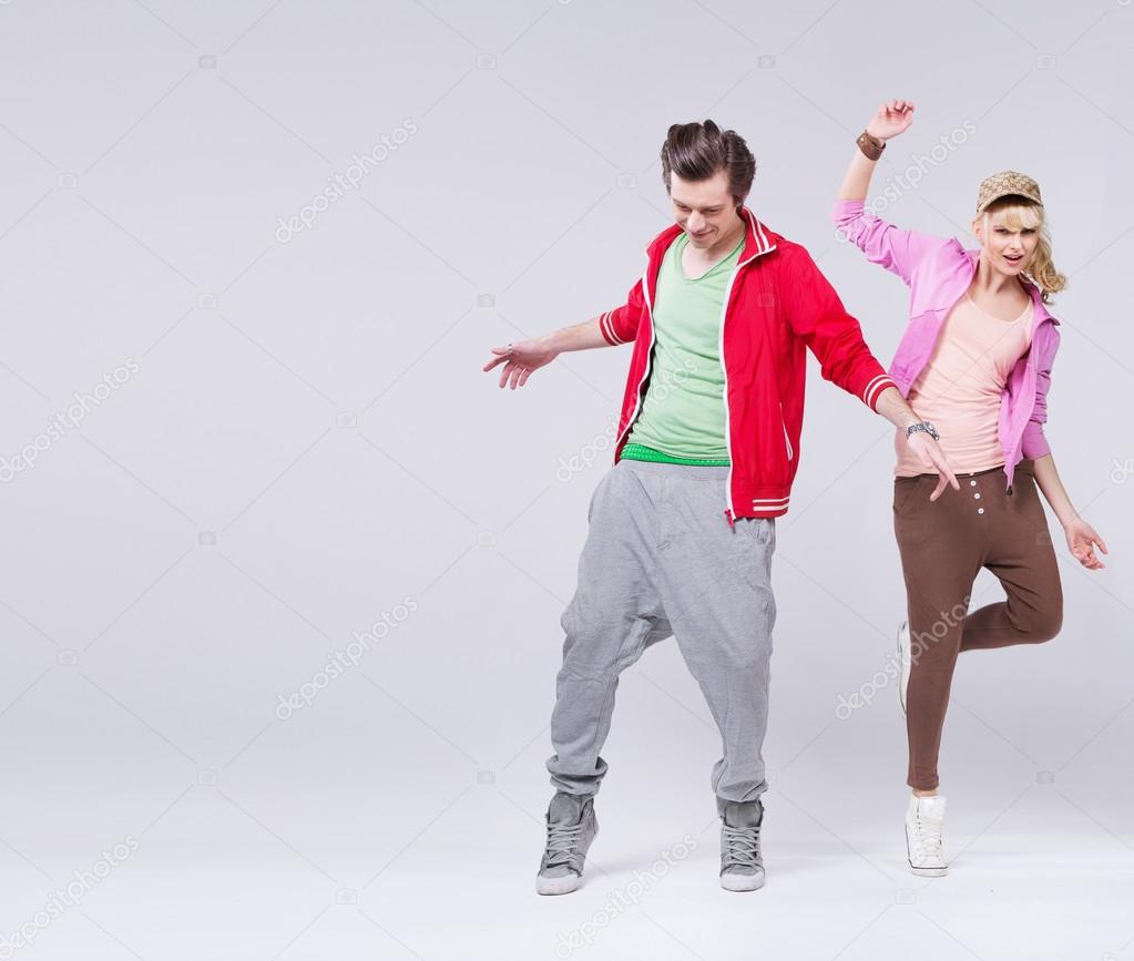 Relaxed couple of teenager in dance pose