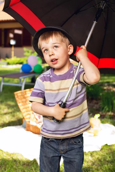 Curious boy with big umbrella — Stock Photo, Image
