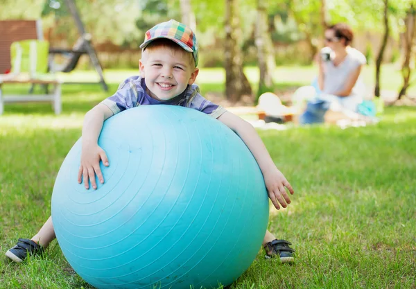 Little gentleman playing a big ball — Stock Photo, Image