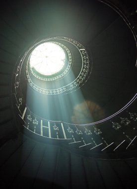 Delicate sunlights among spiral stairs clipart