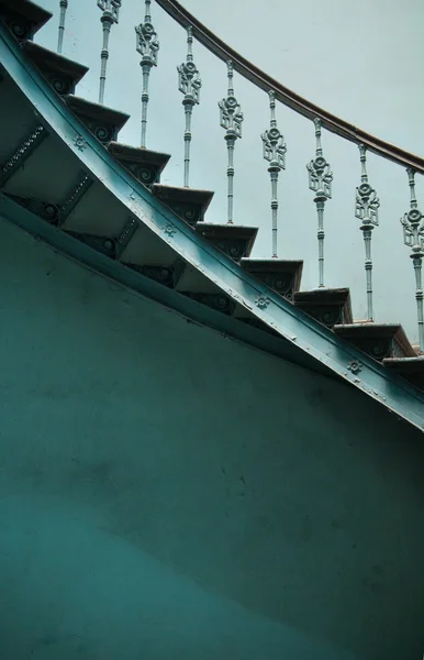 Wooden spiral stairs in ancient interior — Stock Photo, Image