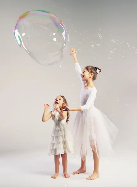 Two sisters with the large soap bubble — Stock Photo, Image