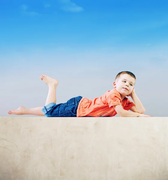 Little man relaxing after tiring play — Stock Photo, Image