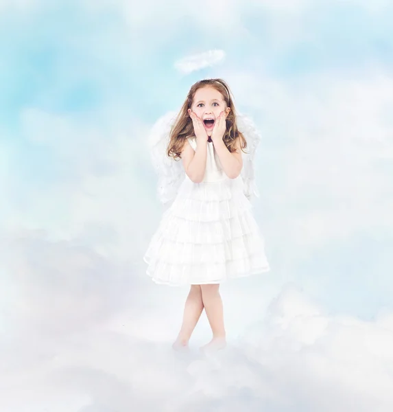 Surprised cheerful little girl among clouds — Stock Photo, Image