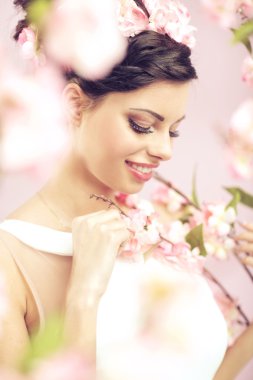 Glad brunette lady with the flowers in hair clipart