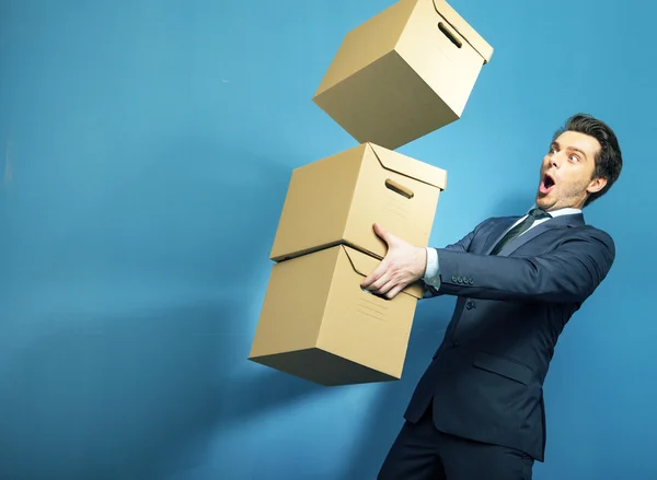 Surprised banker with the boxes — Stock Photo, Image