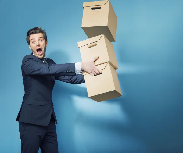 Surprised smart banker with the boxes — Stock Photo, Image