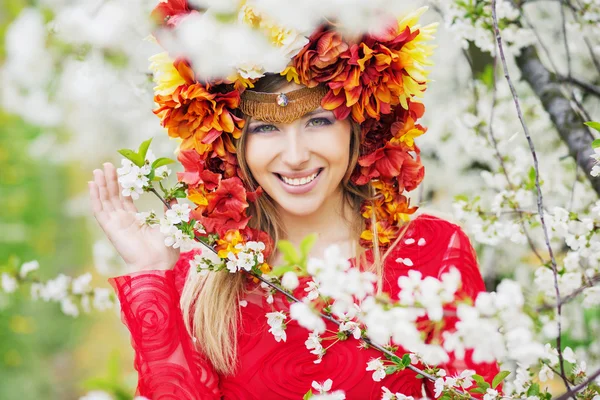 Mooie vrouw met de kleurrijke bloemrijke hoed — Stockfoto