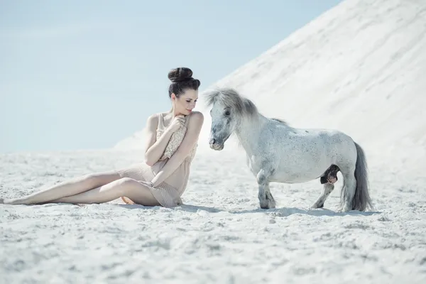 Charming lady playing with the pony — Stock Photo, Image