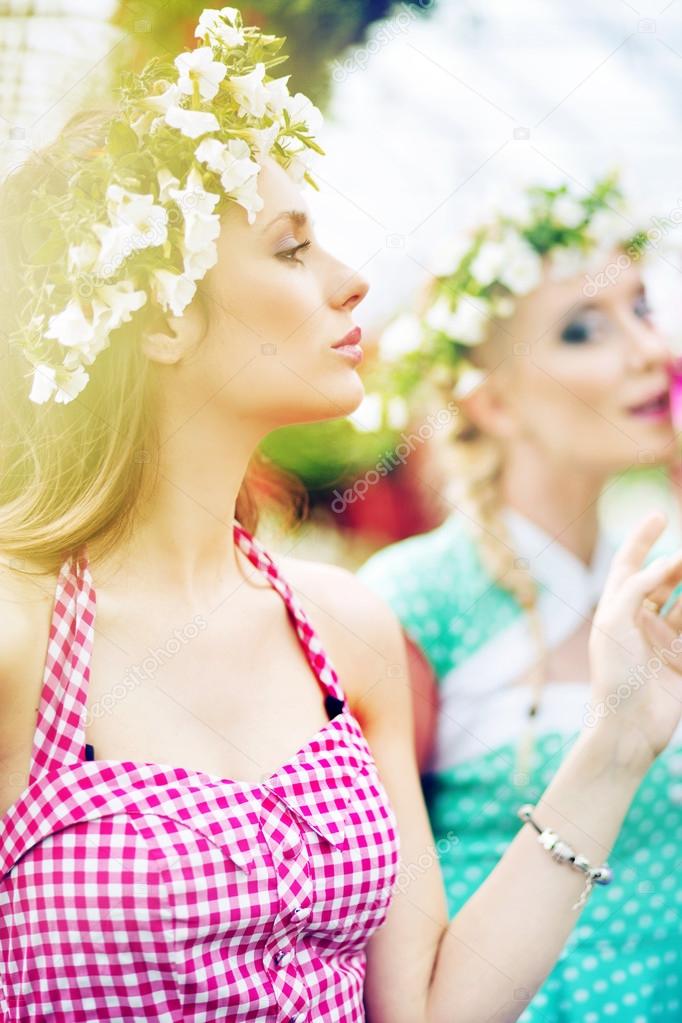 Two gorgeus women in the fresh garden