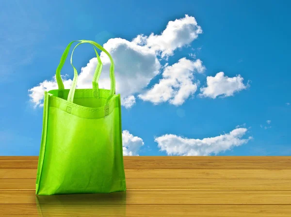 Shopping bag on wooden table with nice sky — Stock Photo, Image