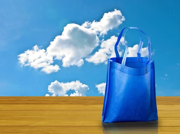 Shopping bag on wooden table with nice sky — Stock Photo, Image