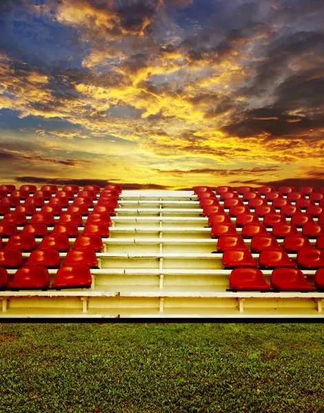 Red bleachers with sunset sky background — Stock Photo, Image