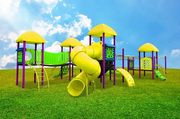 Children's playground in garden with nice sky — Stock Photo, Image