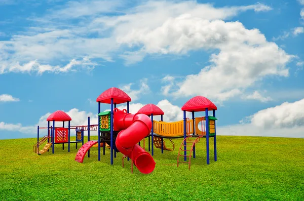 Children's playground in garden with nice sky — Stock Photo, Image