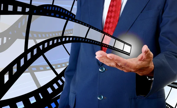 Film strip in businessman hand, Cinema industrial — Stock Photo, Image
