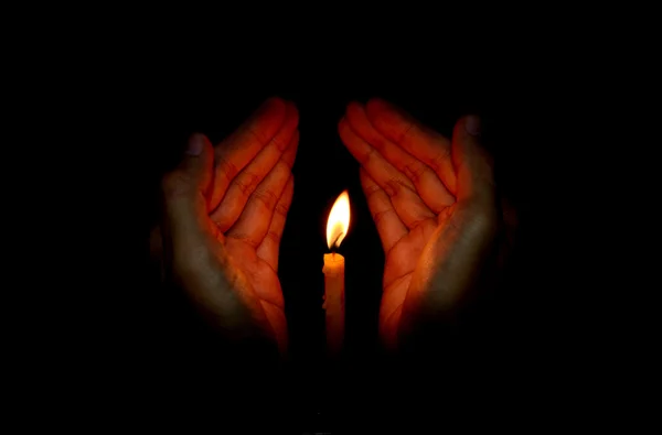 Свеча в руке, молитвенная концепция — стоковое фото