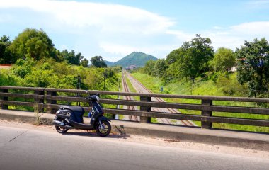 CHONBURI, THAILAND - 28 JUNE : Motorbike parking at bridge over railway on 28 June 2021 in Sriracha, Chonburi, Thailand