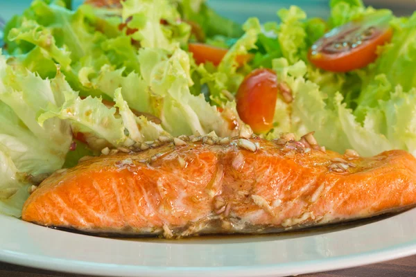 Salmon steak on top with sauce — Stock Photo, Image