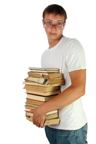 Murid muda dengan kacamata memegang tumpukan buku — Stok Foto