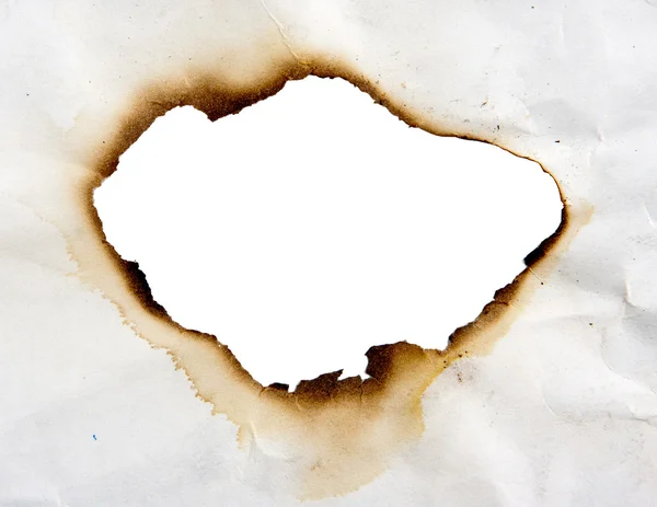 Burned hole in paper — Stock Photo, Image