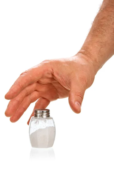 Mão tomando adega de sal — Fotografia de Stock