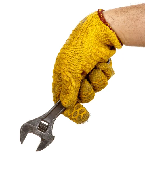 Adjustable wrench in hand with glove — Stock Photo, Image