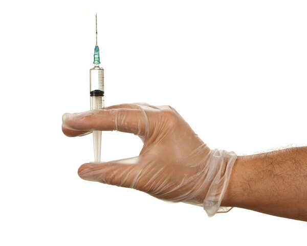 Hand in latex glove holding syringe