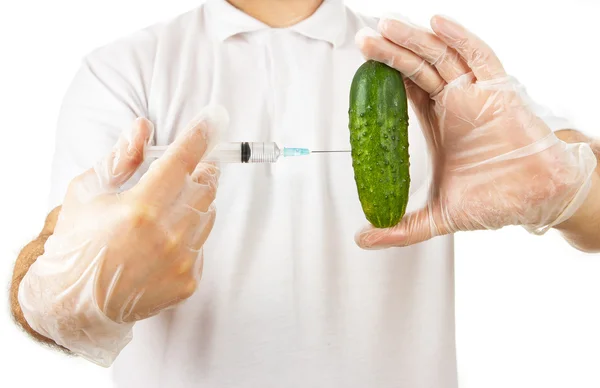 Hands making injection to cucumber — Stock Photo, Image