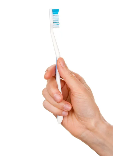 Mão de mulher segurando escova de dentes — Fotografia de Stock