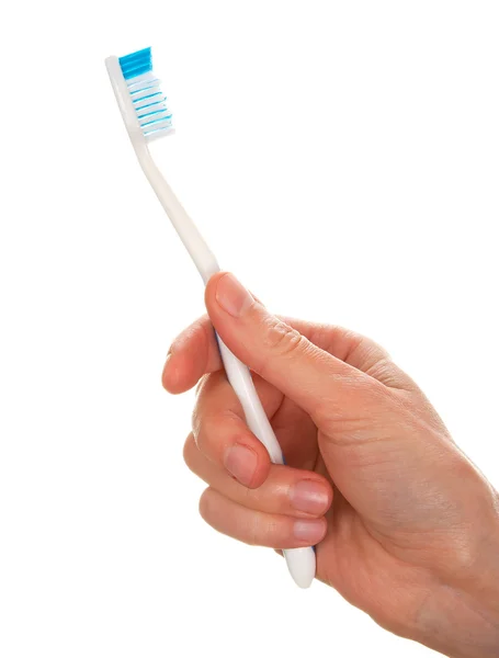 Mão de mulher segurando escova de dentes — Fotografia de Stock
