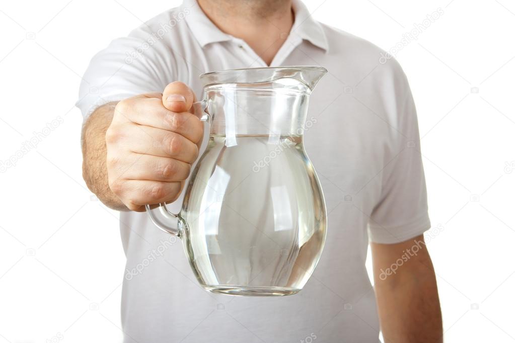 Male in white shirt giving jug of water