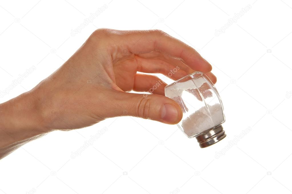 Female hand holding salt cellar