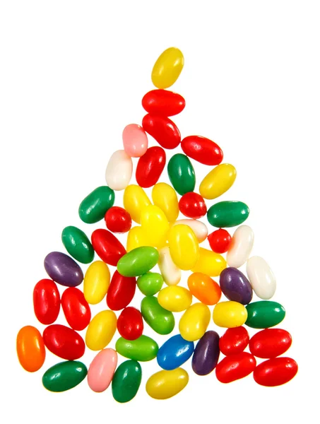 Color jelly beans in shape of triangle over a — Stock Photo, Image