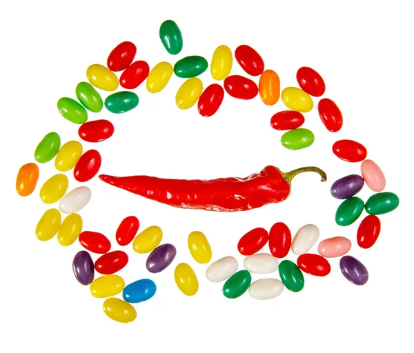 Hot chilli pepper and sweet jelly beans — Stock Photo, Image