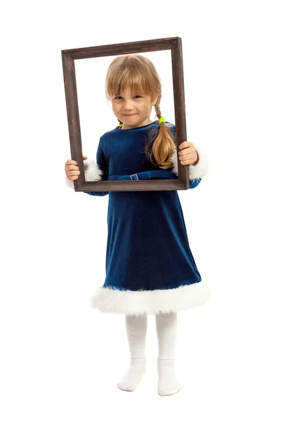 Little girl looking trough wooden frame — Stock Photo, Image