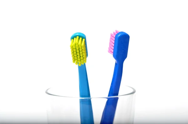 Colorful toothbrushes in a glass — Stock Photo, Image