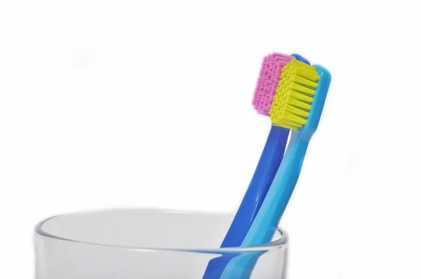 Colorful toothbrushes in a glass Royalty Free Stock Images