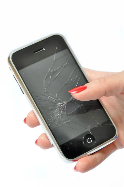 Girl with red nails holding a Mobile phone with broken screen — Stock Photo, Image